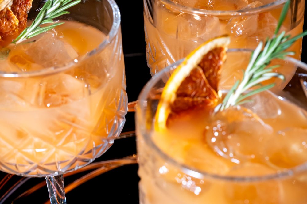 Rosemary-crowned cocktails catching the light