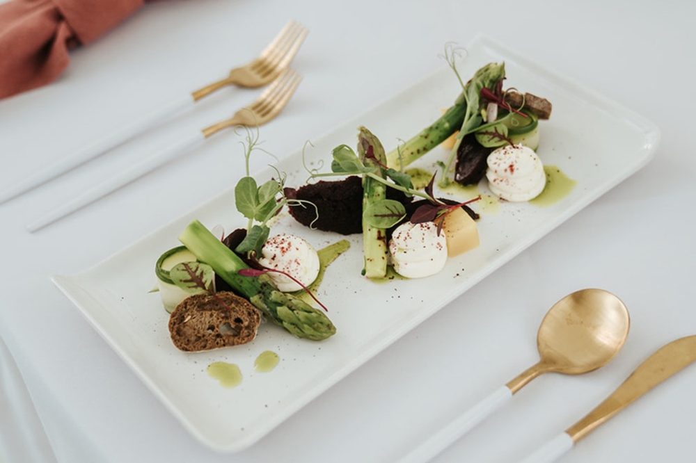 A starter plated with edible flowers and micro herbs